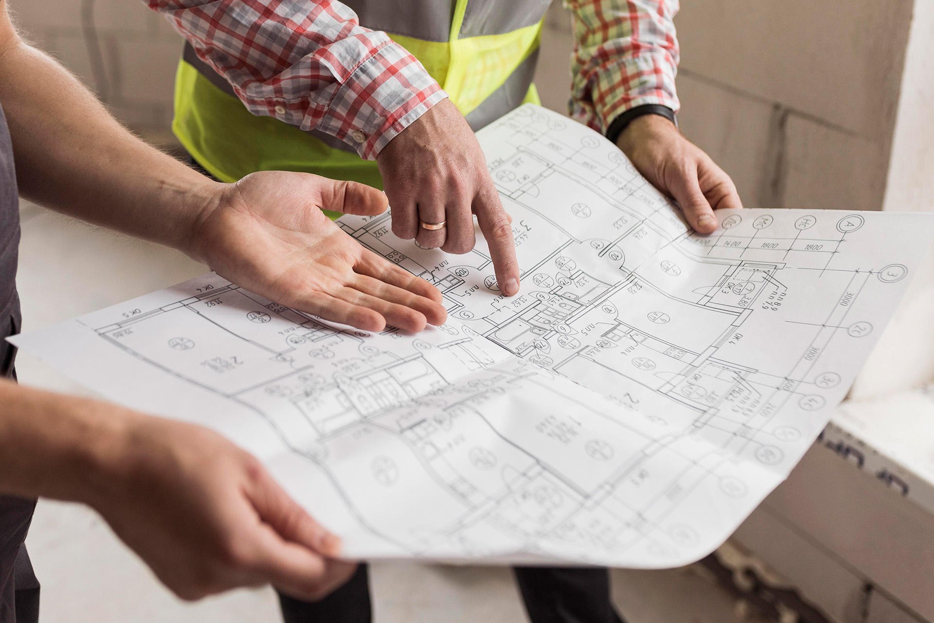 Two Building Surveyors Pointing At Building Plans To Request Licence To Alter