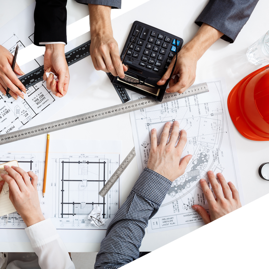 Team Looking Over Residential And Commercial Building Plans At JTM Building Consultancy